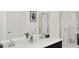 Bright bathroom with double vanity, modern fixtures, and a glass-enclosed shower at 7656 Gemstone St, Groveland, FL 34736