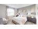 Inviting bedroom with a large window, plush bedding, and stylish decor at 7656 Gemstone St, Groveland, FL 34736