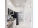 Contemporary kitchen featuring stainless appliances, white cabinets, and ample counter space at 7656 Gemstone St, Groveland, FL 34736