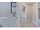 Bathroom featuring a modern vanity with black framed mirror, light fixture, and tile flooring at 2769 Corrigan Dr, Deltona, FL 32738