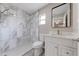Updated bathroom featuring marble tile, chrome fixtures, and modern vanity with large mirror at 2769 Corrigan Dr, Deltona, FL 32738
