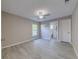 Spacious bedroom with neutral walls, gray floors, window, and access to the ensuite bathroom at 2769 Corrigan Dr, Deltona, FL 32738