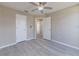 A bright bedroom featuring neutral walls, gray flooring, and two doors at 2769 Corrigan Dr, Deltona, FL 32738