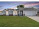 Charming single-story home featuring a well-manicured lawn, gray exterior, and attached two-car garage at 2769 Corrigan Dr, Deltona, FL 32738