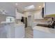 Bright kitchen featuring white cabinets, stainless steel appliances, a breakfast bar, and ample natural light at 2769 Corrigan Dr, Deltona, FL 32738
