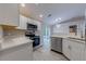 Updated kitchen with modern appliances, white cabinetry, and a breakfast bar overlooking the living area at 2769 Corrigan Dr, Deltona, FL 32738