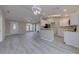 Inviting space with wood flooring, vaulted ceilings, modern lighting, and an open layout to the kitchen at 2769 Corrigan Dr, Deltona, FL 32738
