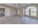 Spacious living room with gray flooring, a large arched window, and direct access to the front door at 2769 Corrigan Dr, Deltona, FL 32738