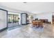 Open dining area featuring tile floors, a round wooden table, and views of the outdoor patio through French doors at 4821 S Gachet Blvd, Lakeland, FL 33813