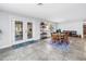 Open dining area featuring tile floors, a round wooden table, and views of the outdoor patio through French doors at 4821 S Gachet Blvd, Lakeland, FL 33813