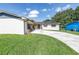The front of the house features a well-manicured lawn and inviting front entrance, with a long driveway at 4821 S Gachet Blvd, Lakeland, FL 33813