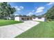 Charming single-story home featuring well-maintained lawn, large driveway, and solar panels at 4821 S Gachet Blvd, Lakeland, FL 33813