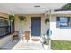 The cozy front porch is decorated with hanging plants, chairs, and a cute welcome sign at 4821 S Gachet Blvd, Lakeland, FL 33813