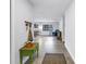 The long hallway leading to the living area has tile floors and a vintage green accent table at 4821 S Gachet Blvd, Lakeland, FL 33813