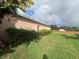 Large backyard with lush green lawn, privacy landscaping, and a partial fence at 2163 Wintermere Pointe Dr, Winter Garden, FL 34787