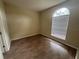 This bedroom features wood floors, a rounded window, and neutral color at 2163 Wintermere Pointe Dr, Winter Garden, FL 34787
