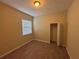 This bedroom features wood floors, a window, a neutral color, and a closet at 2163 Wintermere Pointe Dr, Winter Garden, FL 34787
