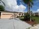Charming single-story home featuring a two car garage, a lawn, and mature landscaping at 2163 Wintermere Pointe Dr, Winter Garden, FL 34787