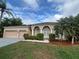 Charming single-story home featuring a manicured lawn and a three car garage at 2163 Wintermere Pointe Dr, Winter Garden, FL 34787