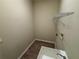 This laundry room features wood floors, laundry sink, and a metal rack at 2163 Wintermere Pointe Dr, Winter Garden, FL 34787
