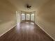 This living room features wood floors, a ceiling fan, and arched windows at 2163 Wintermere Pointe Dr, Winter Garden, FL 34787
