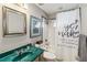 Bathroom with an ornate mirror above the sink and a tub/shower with a shower curtain at 25302 Lido Ave, Sorrento, FL 32776