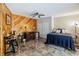 Well-lit bedroom featuring wood paneling, a ceiling fan, and tiled flooring at 25302 Lido Ave, Sorrento, FL 32776