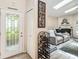 Welcoming foyer with decorative door and a view into the spacious living room with fireplace at 25302 Lido Ave, Sorrento, FL 32776