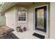 Inviting front entrance with decorative glass door, side window, potted plants and a covered porch at 25302 Lido Ave, Sorrento, FL 32776