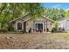 Home exterior with a cozy front porch and lush landscaping, enhancing curb appeal at 25302 Lido Ave, Sorrento, FL 32776