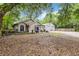 Charming home with well-manicured lawn and landscaping, featuring a large detached garage at 25302 Lido Ave, Sorrento, FL 32776