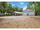 Home exterior featuring a large detached garage with ample parking and landscaping at 25302 Lido Ave, Sorrento, FL 32776