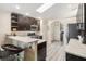 Stylish kitchen featuring dark cabinetry, stainless steel appliances, and an open layout with a breakfast bar at 25302 Lido Ave, Sorrento, FL 32776