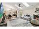 Bright, open living room with vaulted ceilings, skylights, fireplace and wood look floors that flow into the dining area at 25302 Lido Ave, Sorrento, FL 32776