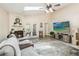 Inviting living room with a cozy fireplace, French doors, skylight and modern decor at 25302 Lido Ave, Sorrento, FL 32776