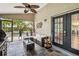 Relaxing screened patio with comfortable seating and views of the pool and lush backyard at 25302 Lido Ave, Sorrento, FL 32776