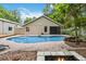 Gorgeous backyard pool and patio area with mature trees, a fire pit, and lush landscaping at 25302 Lido Ave, Sorrento, FL 32776