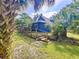 Scenic backyard showcasing stairs leading up to the property, and lush landscaping at 2900 Cr 415, Lake Panasoffkee, FL 33538
