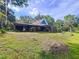 Home featuring a covered backyard space perfect for relaxing or entertaining with lush green surroundings at 2900 Cr 415, Lake Panasoffkee, FL 33538