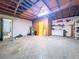 Unfinished basement featuring open ceiling, water heater, utility sink and cabinet, and doorway at 2900 Cr 415, Lake Panasoffkee, FL 33538