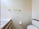 Bathroom featuring a white tile half wall, toilet, and vanity with a white sink at 2900 Cr 415, Lake Panasoffkee, FL 33538
