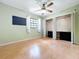 Bedroom with wood floors, ceiling fan, a window, and closet with sliding doors at 2900 Cr 415, Lake Panasoffkee, FL 33538