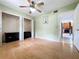 Bedroom with closet, window, wood floors, ceiling fan, and a doorway to another room at 2900 Cr 415, Lake Panasoffkee, FL 33538