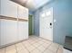 Clean entryway with tiled floors, built in cabinets, and a white door at 2900 Cr 415, Lake Panasoffkee, FL 33538