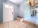 Foyer with white door, tiled flooring, and staircase at 2900 Cr 415, Lake Panasoffkee, FL 33538