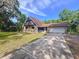 Unique home with stone accents and a large garage, situated on a well-maintained lawn and paved driveway at 2900 Cr 415, Lake Panasoffkee, FL 33538