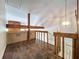 Second story hallway with spiral staircase overlooks open floorplan of the home at 2900 Cr 415, Lake Panasoffkee, FL 33538