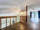 Second story hallway with wood floors overlooks open floorplan and large sliding glass door at 2900 Cr 415, Lake Panasoffkee, FL 33538