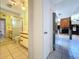 View from hallway showing a bathroom with shower and a living room with wood fireplace at 2900 Cr 415, Lake Panasoffkee, FL 33538