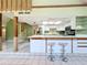 Bright kitchen with breakfast bar, white cabinets, stainless steel appliances, and spiral staircase access at 2900 Cr 415, Lake Panasoffkee, FL 33538